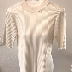 ELBOW LENTH SLEEVES ON THIS OFF WHITE SWEATER.